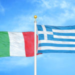 Italy and Greece two flags on flagpoles and blue cloudy sky